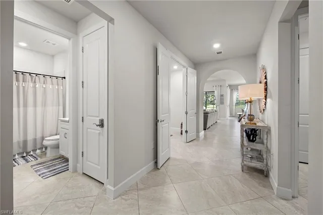 a view of a hallway with bathroom and bathroom