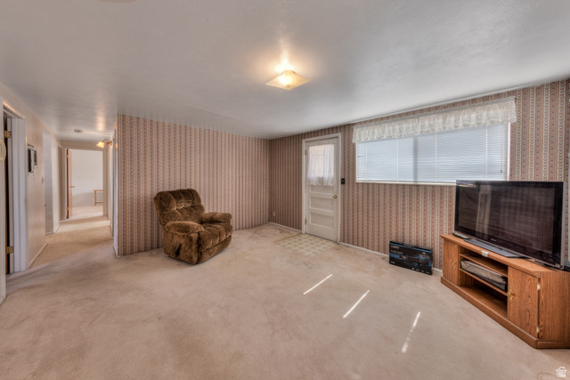 738 Locust Lane Moab, UT 84532 - Photo 13 of 25 Sitting room with wallpapered walls and light colored carpet