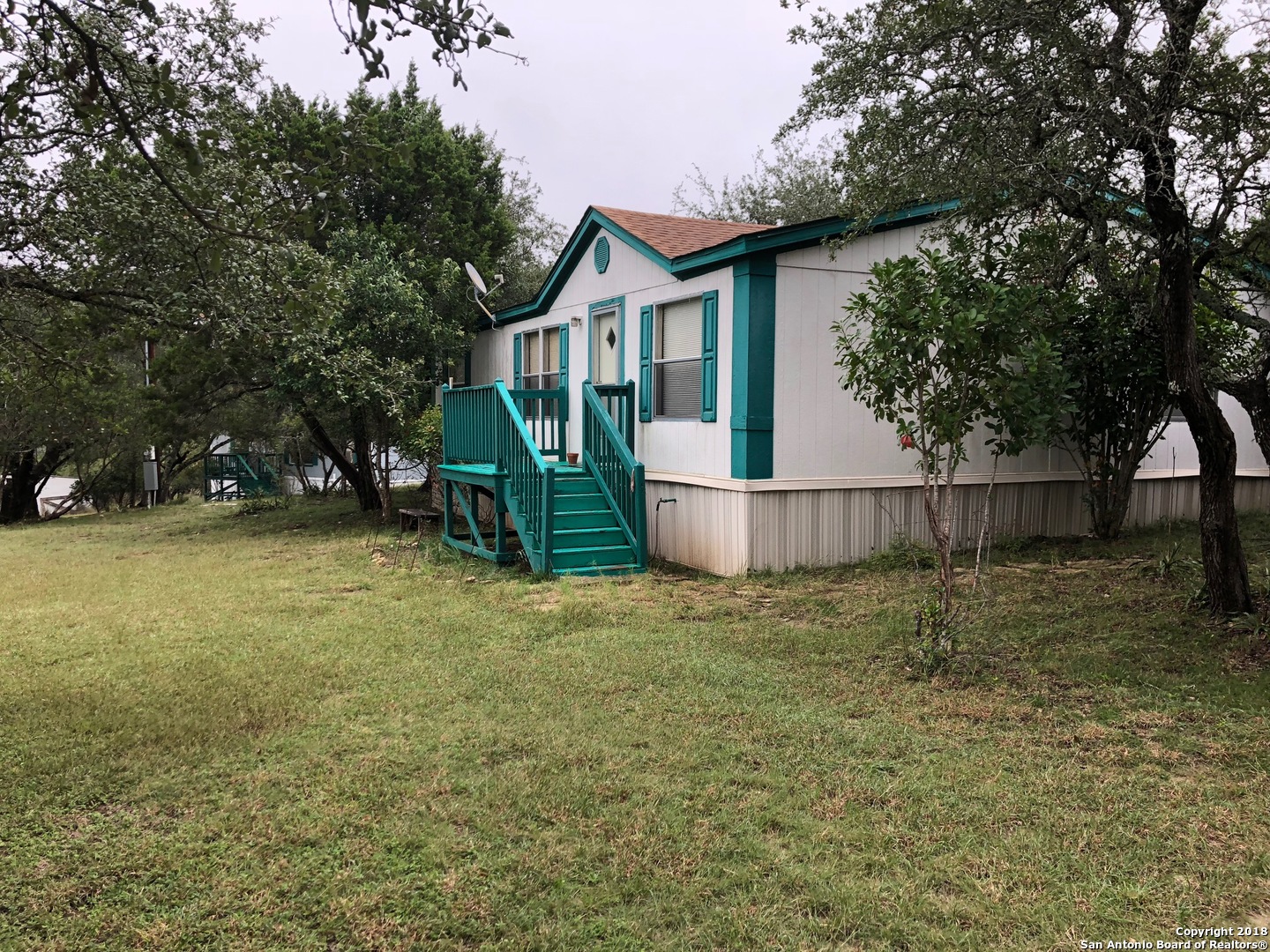 403 Los Indios Road Boerne, TX 78006 - Photo 7 of 21 a house with trees in the background