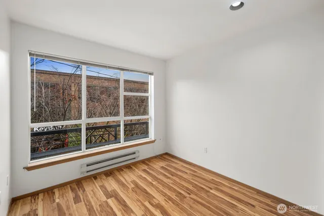 a view of a room with wooden floor and bench