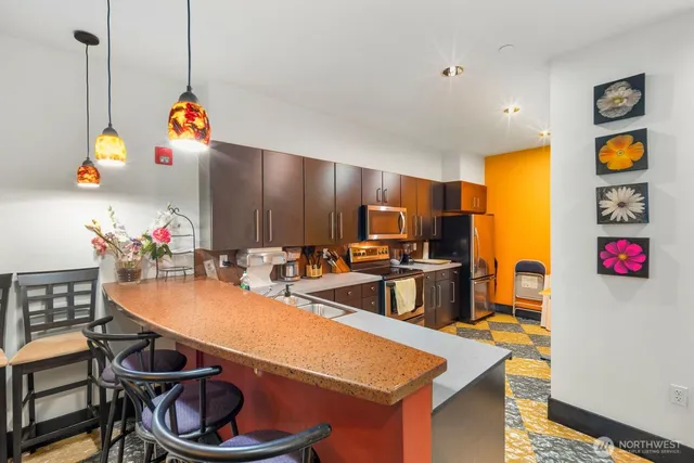 a living room with lots of furniture and baby bed