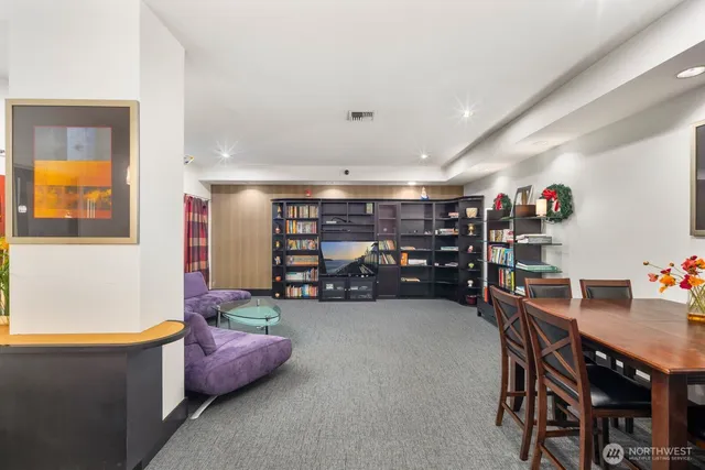 a living room with furniture and gym equipment