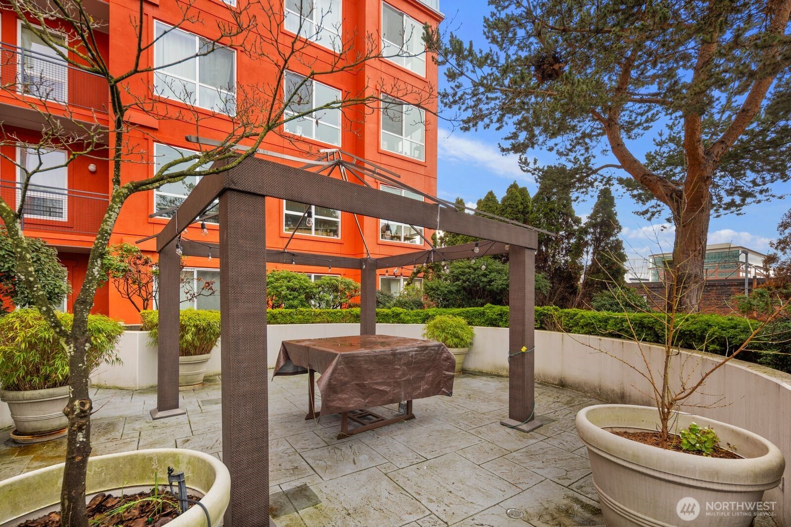 668 South Lane Street, Unit 314 Seattle, WA 98104 - Photo 27 of 36 a backyard of a house with fountain table and chairs