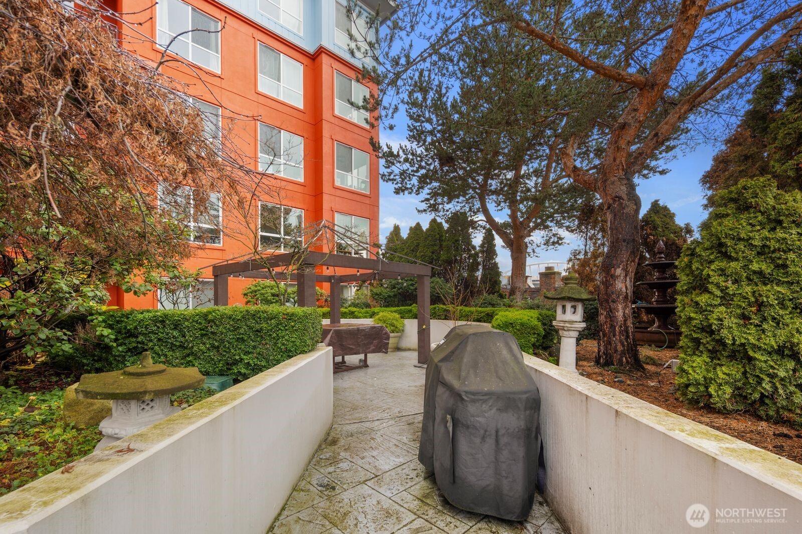 668 South Lane Street, Unit 314 Seattle, WA 98104 - Photo 29 of 36 a view of a garden with tall trees