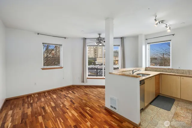 a kitchen with a refrigerator and a wooden cabinets