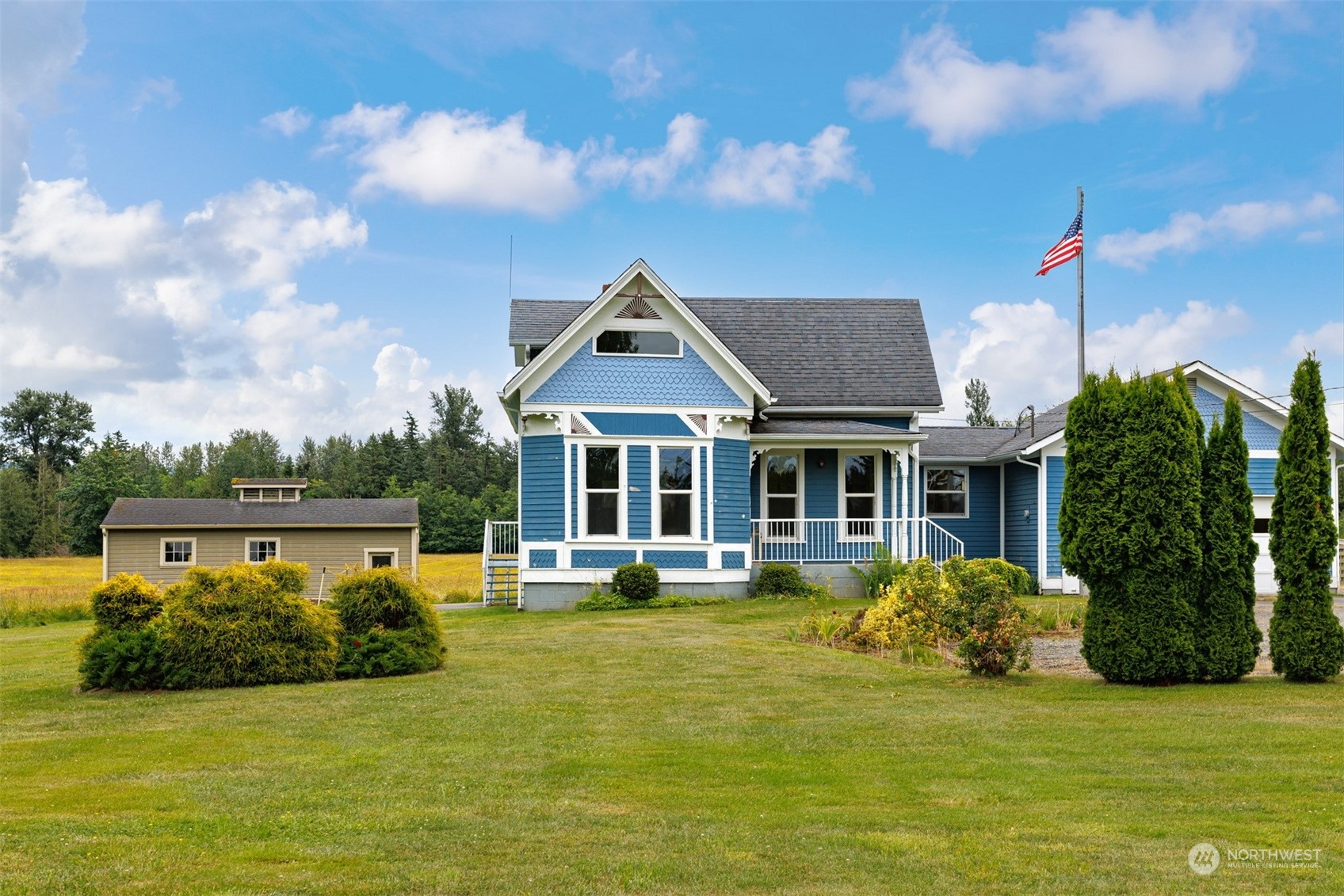 1321 East Axton Road Bellingham, WA 98226 - Photo 3 of 40 a front view of a house with a garden and lake view