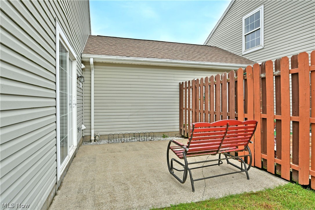 3287 Pheasant Run Road, Unit B Cortland, OH 44410 - Photo 44 of 45 Outdoor concrete patio with a privacy fence, accessible via sliding glass doors