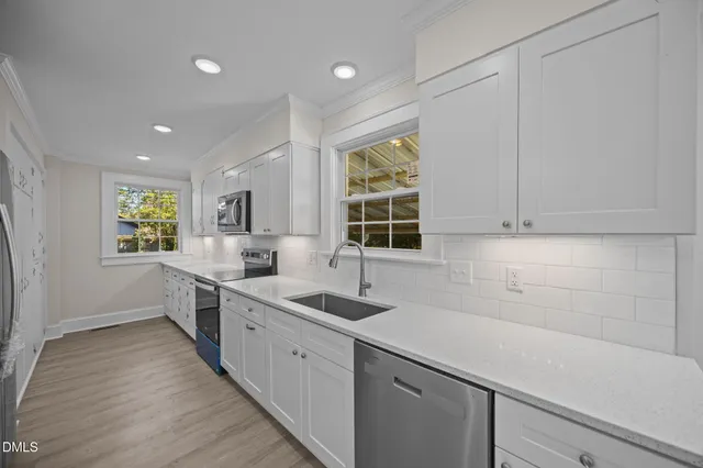 a kitchen with sink cabinets and window