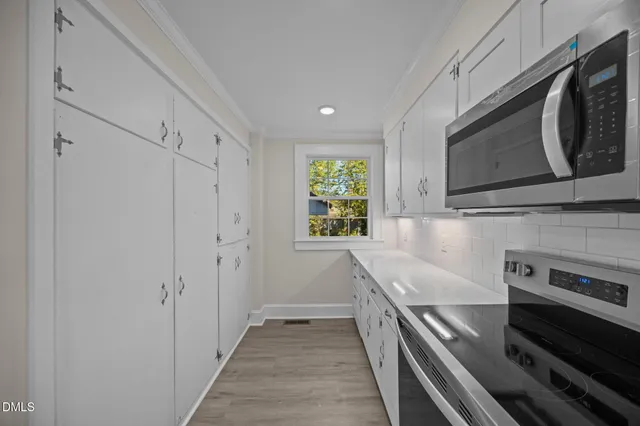 a kitchen with a stove and a microwave