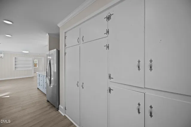 a view of a hallway with wooden floor