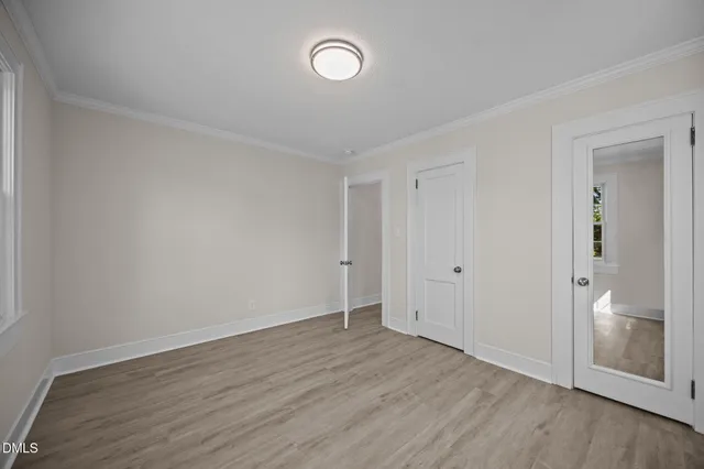 a view of an empty room and wooden floor