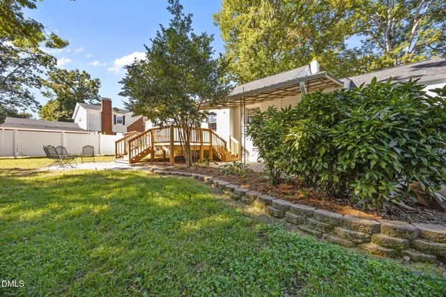a view of a backyard with a garden and trees