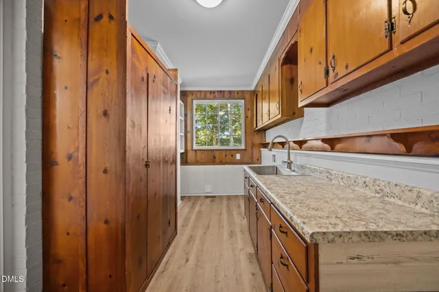 a bathroom with a granite countertop sink and washing machine