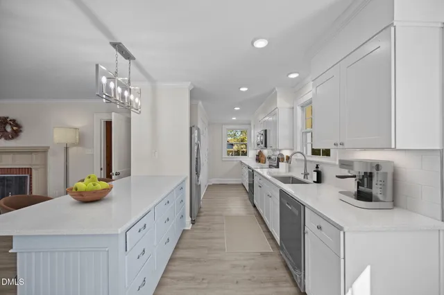 a kitchen with a sink a counter and cabinets