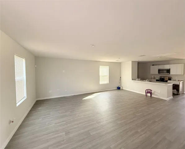 a view of a kitchen with furniture and wooden floor