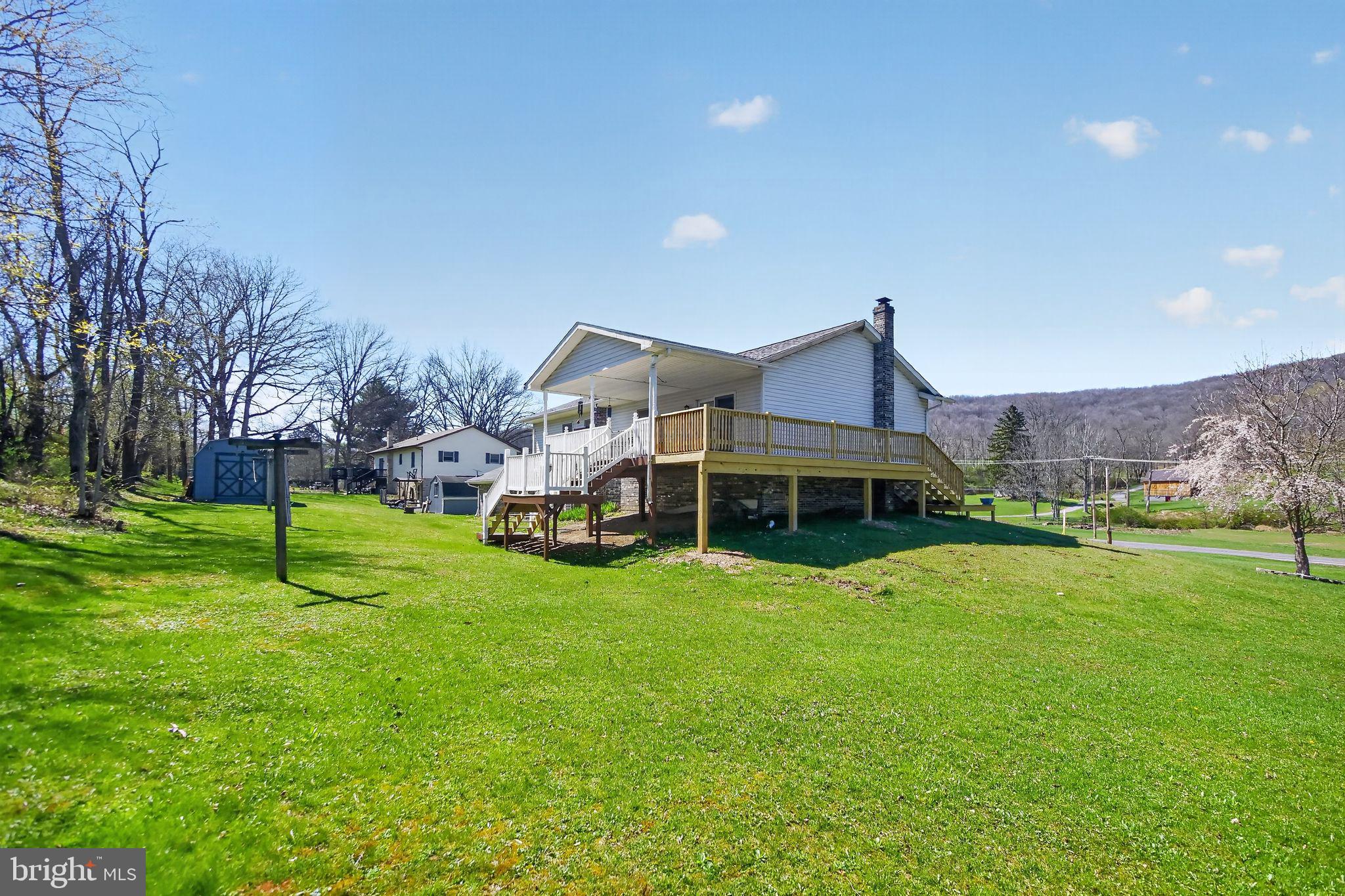 17006 Mt Savage Road Northwest Frostburg, MD 21532 - Photo 2 of 19 a view of a house with a big yard and a large tree