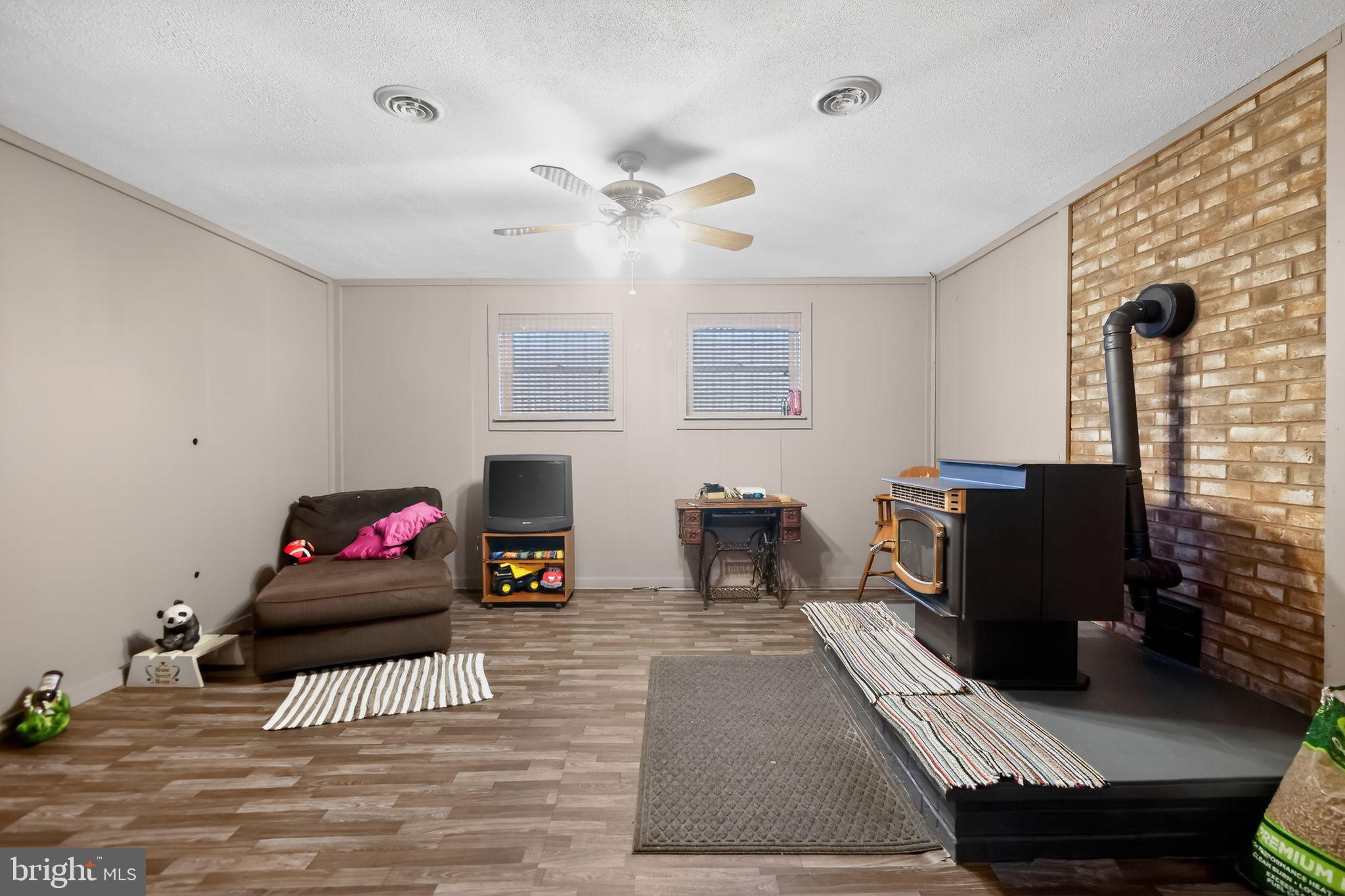 17006 Mt Savage Road Northwest Frostburg, MD 21532 - Photo 6 of 19 a living room with furniture and a fireplace