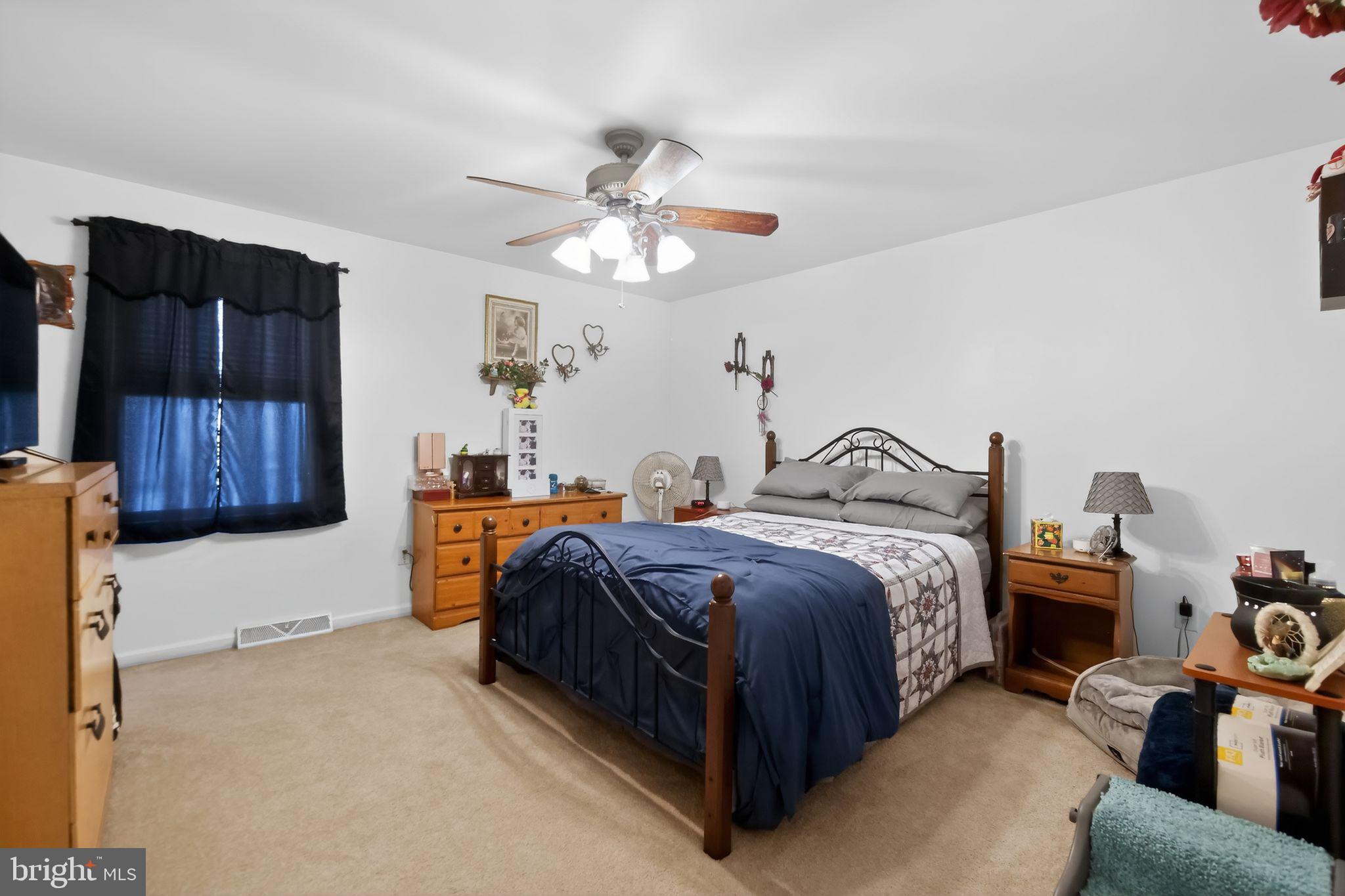 17006 Mt Savage Road Northwest Frostburg, MD 21532 - Photo 9 of 19 a spacious bedroom with a bed and a chandelier