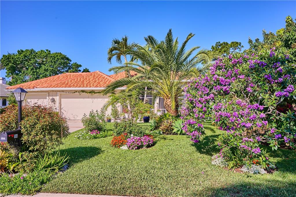 186 Muirfield Circle Naples, FL 34113 - Photo 1 of 36 a view of a flower in a garden