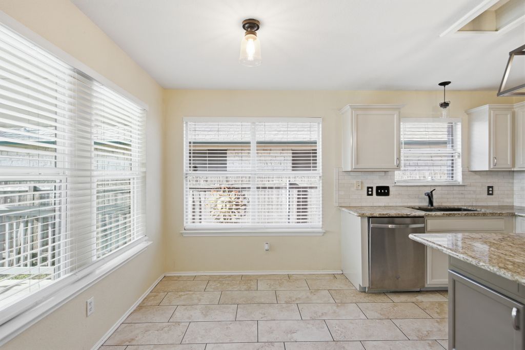 3201 Mocha Trail Austin, TX 78728 - Photo 12 of 26 a kitchen with a sink a stove and cabinets