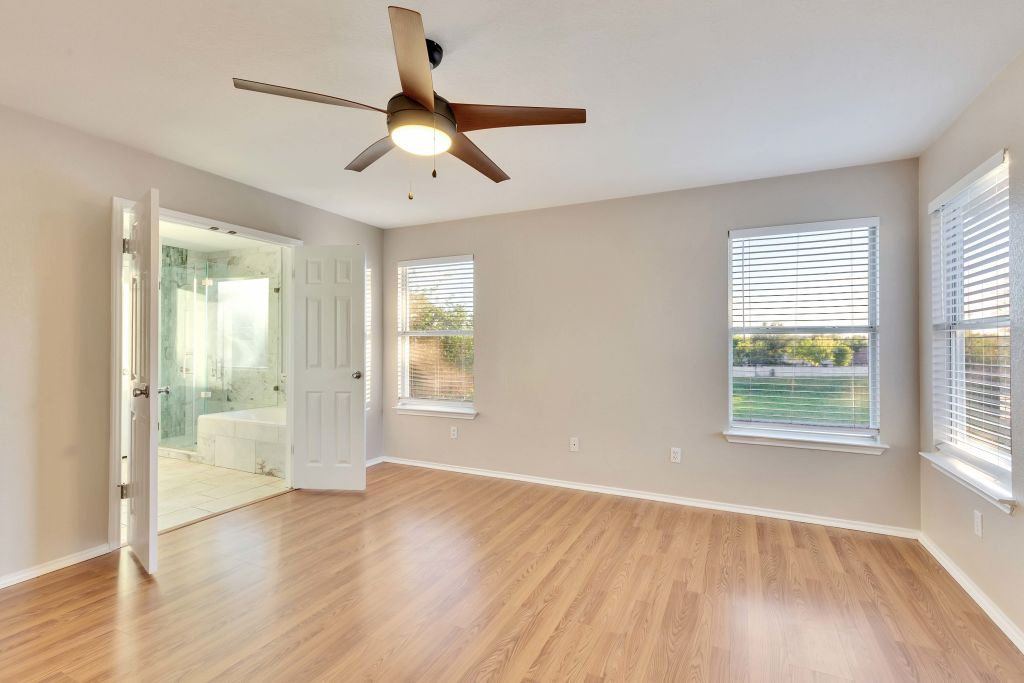 3201 Mocha Trail Austin, TX 78728 - Photo 17 of 26 a view of an empty room with a window and wooden floor
