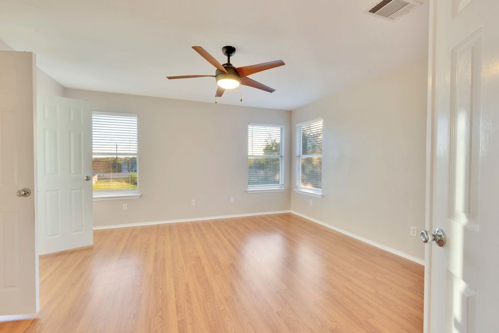 3201 Mocha Trail Austin, TX 78728 - Photo 18 of 26 a view of an empty room with wooden floor and a window