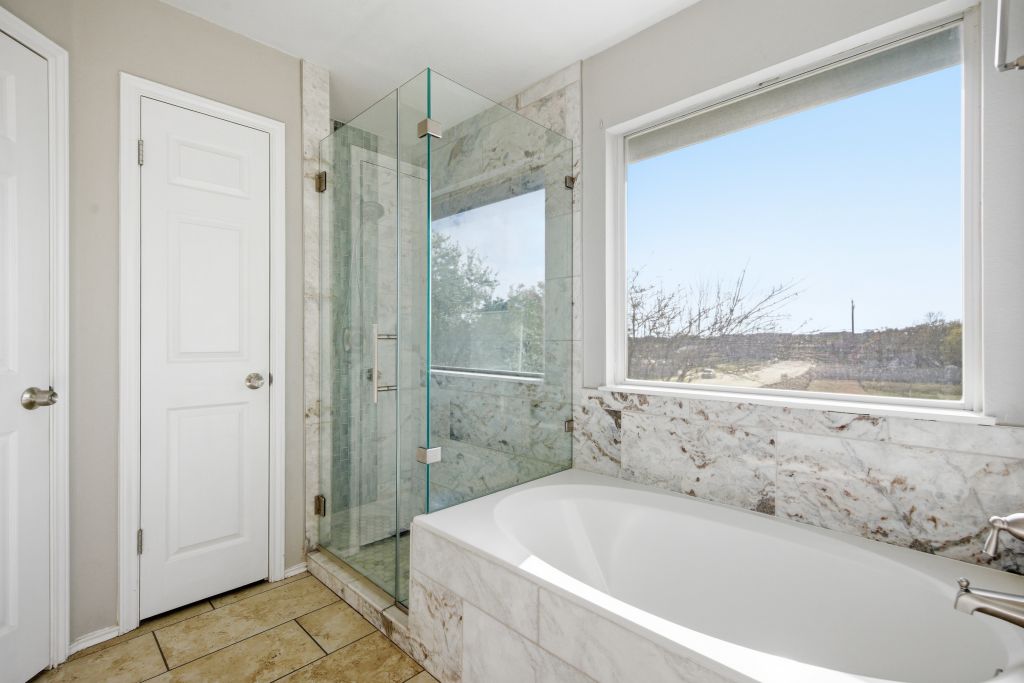 3201 Mocha Trail Austin, TX 78728 - Photo 20 of 26 a bathroom with a bathtub and a shower