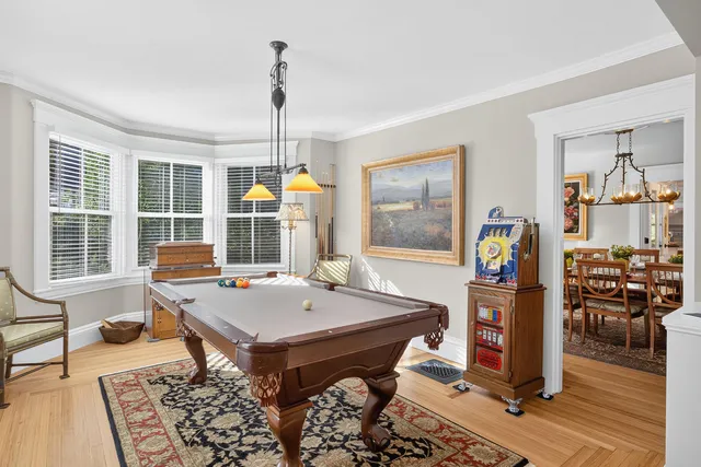 a kitchen with a table chairs stove and wooden floor