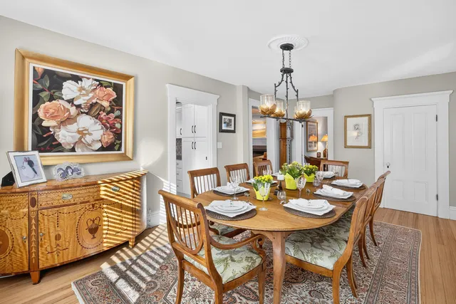 a kitchen with a table chairs stove and cabinets