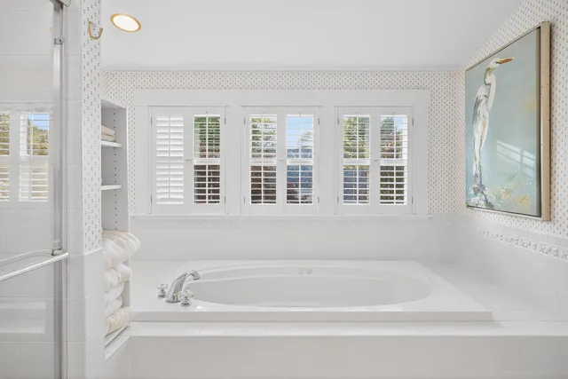 a view of patio with chairs and table under an umbrella