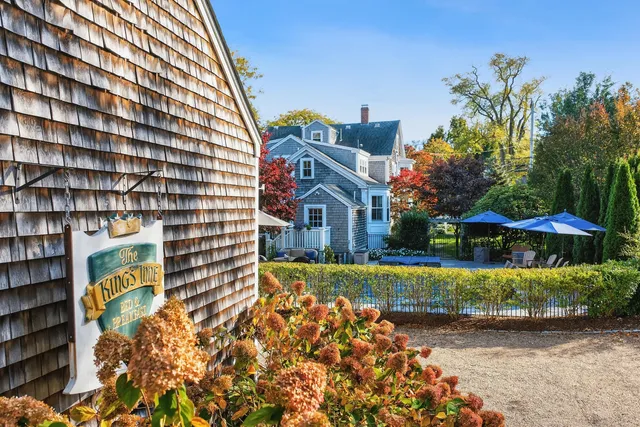 a front view of a house with a yard and flowers