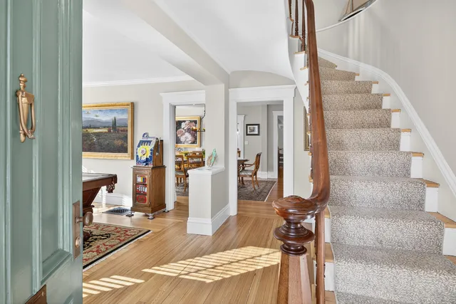 a view of a dining room with furniture wooden floor and a chandelier