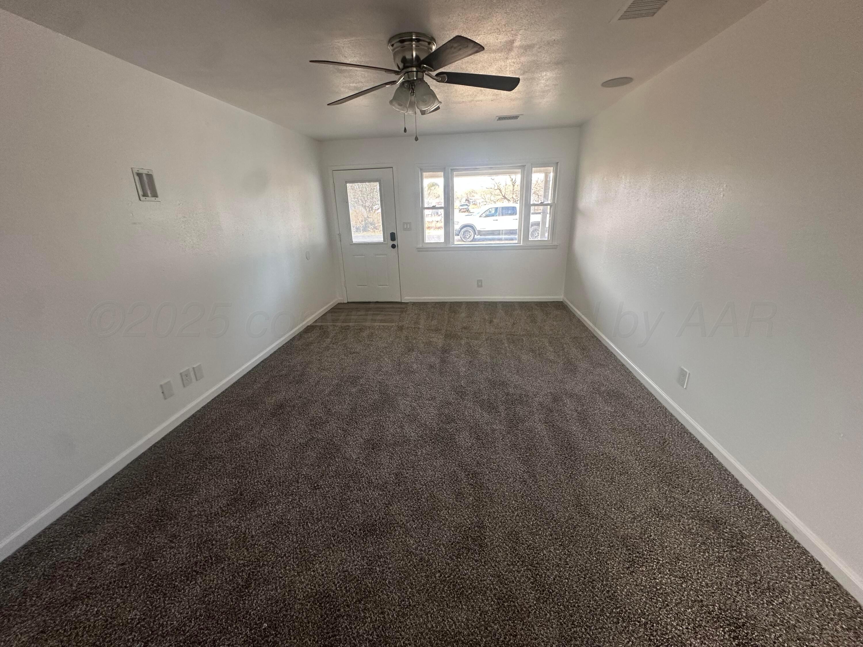 4854 Morning Drive Amarillo, TX 79108 - Photo 12 of 22 an empty room with windows and ceiling fan
