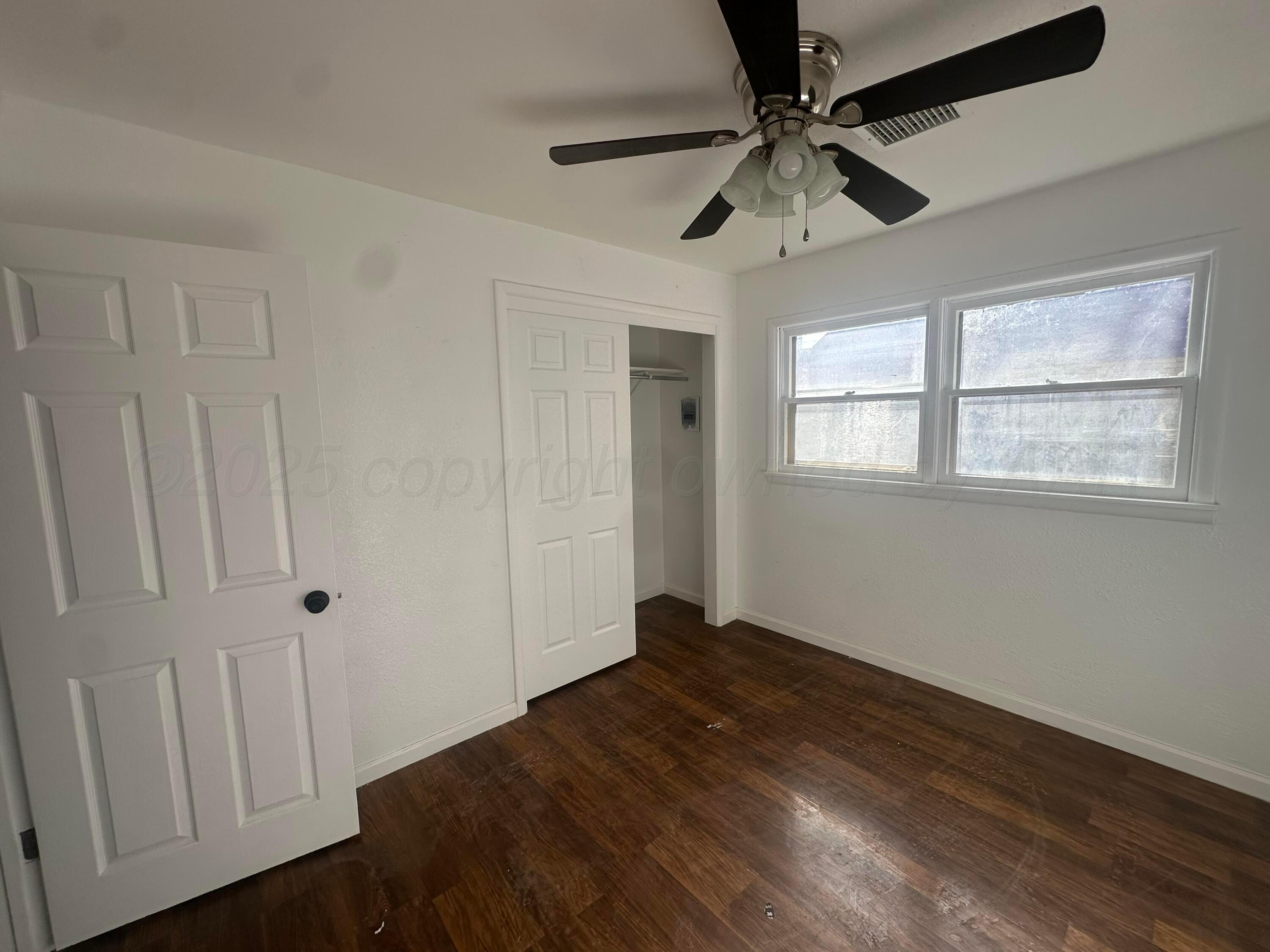 4854 Morning Drive Amarillo, TX 79108 - Photo 16 of 22 a view of an empty room with a window and wooden floor