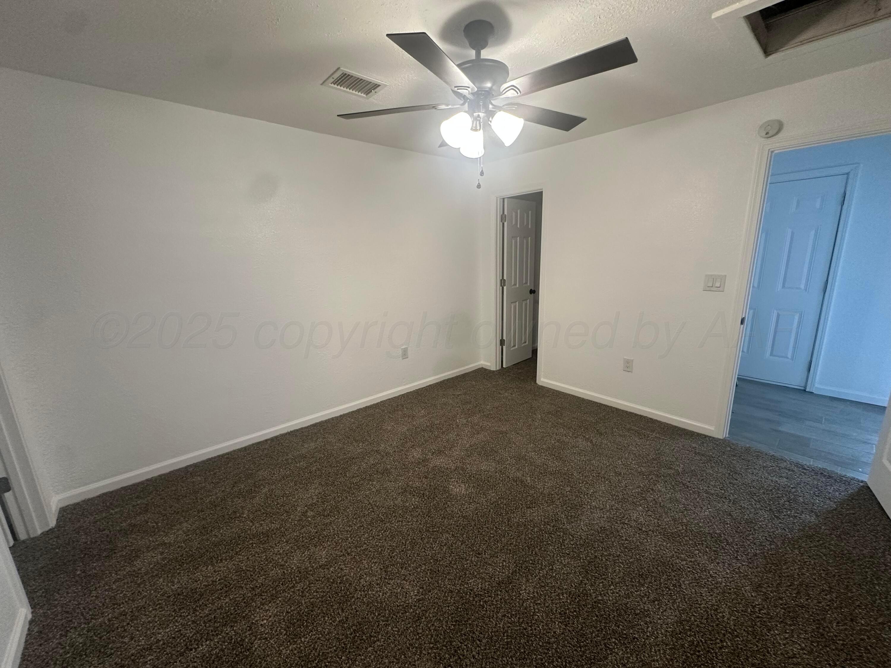 4854 Morning Drive Amarillo, TX 79108 - Photo 17 of 22 an empty room with a view of a livingroom