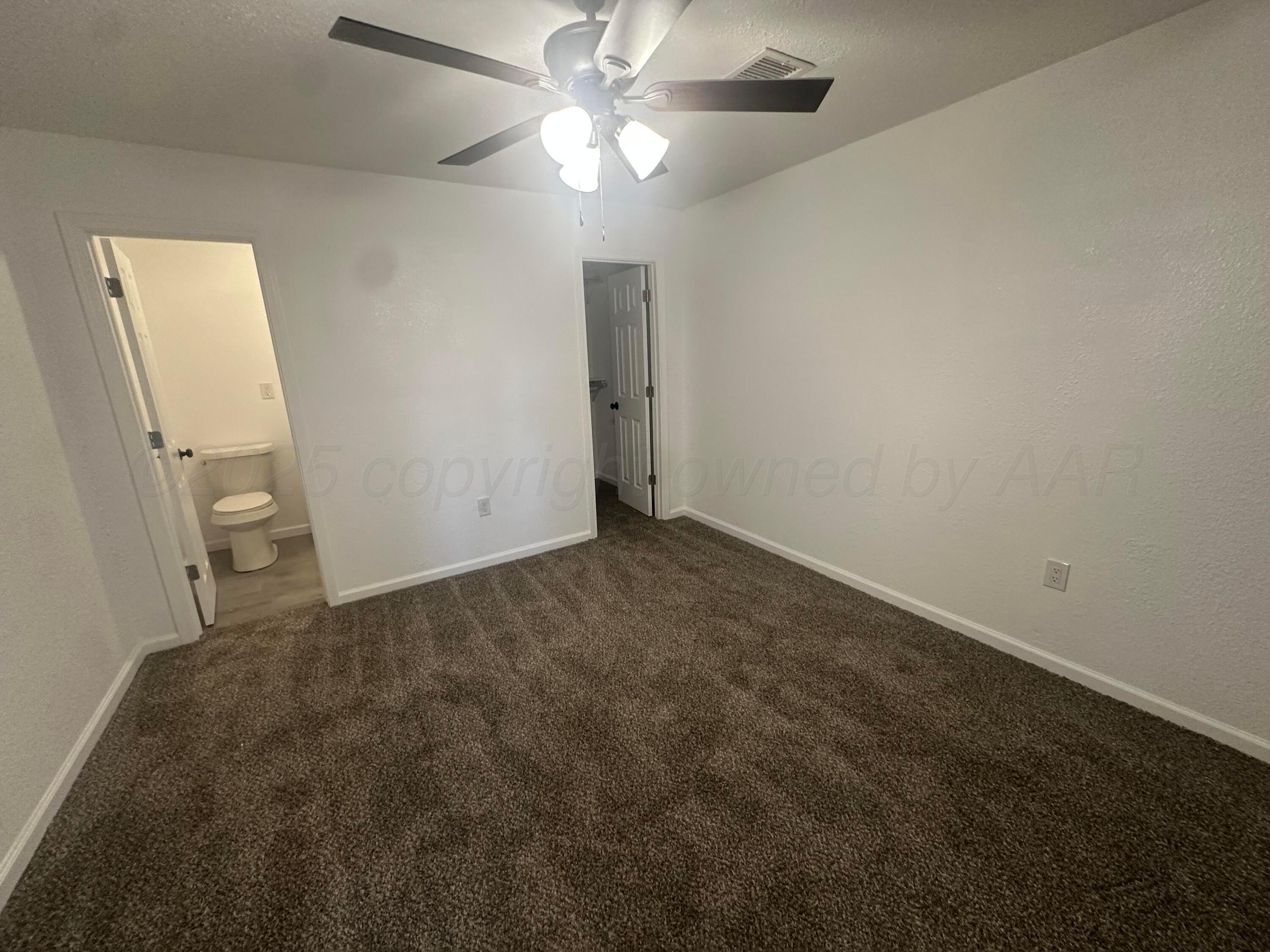 4854 Morning Drive Amarillo, TX 79108 - Photo 20 of 22 an empty room with a ceiling fan and bathroom