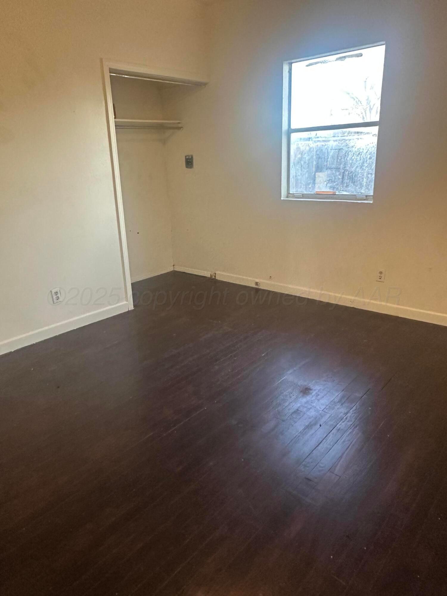 4854 Morning Drive Amarillo, TX 79108 - Photo 21 of 22 an empty room with wooden floor and windows