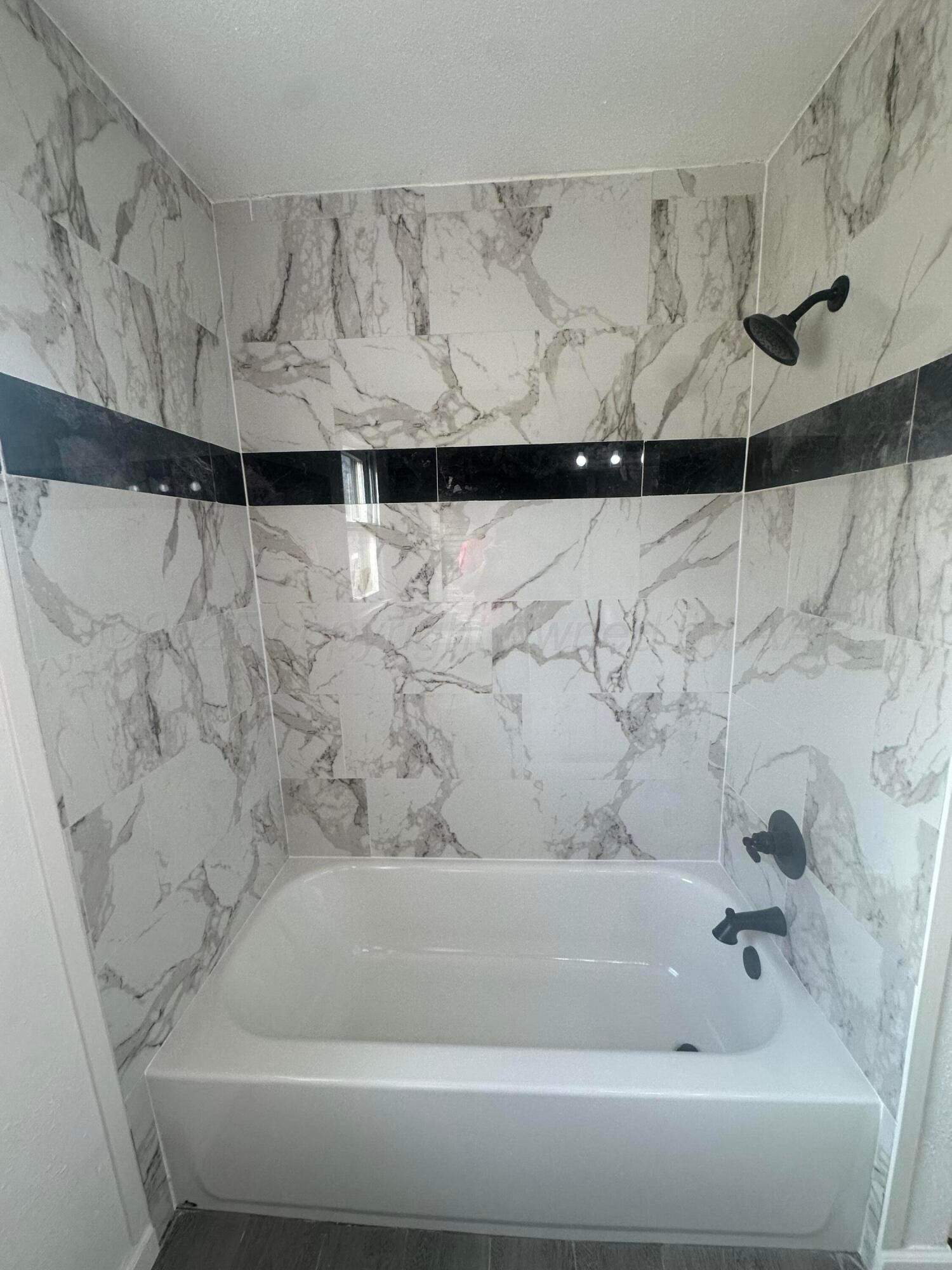 4854 Morning Drive Amarillo, TX 79108 - Photo 3 of 22 a bathroom with a bathtub and shower