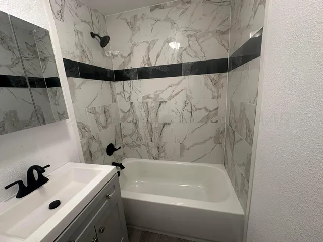 a bathroom with a sink and a bathtub