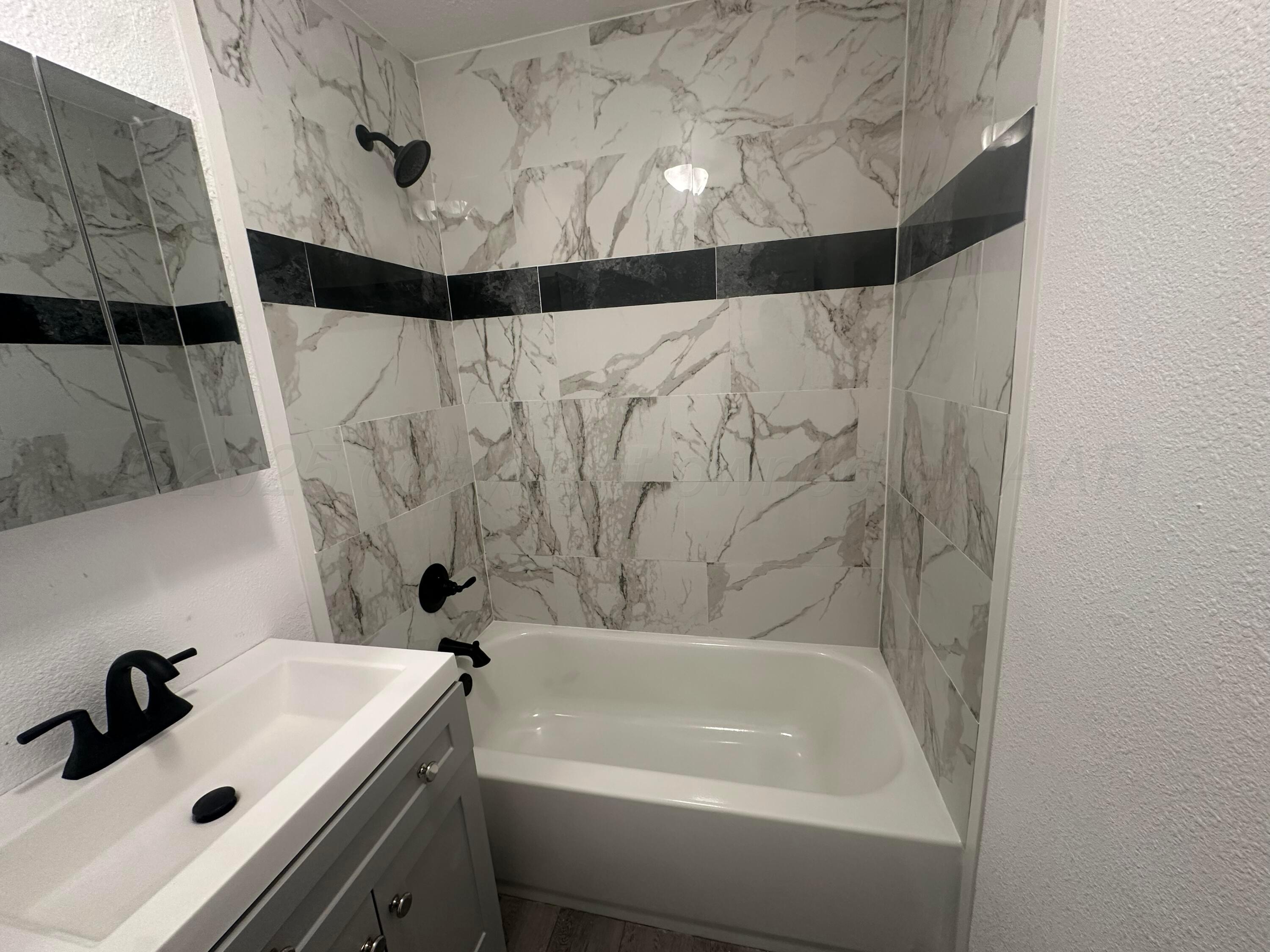 4854 Morning Drive Amarillo, TX 79108 - Photo 7 of 22 a bathroom with a sink and a bathtub