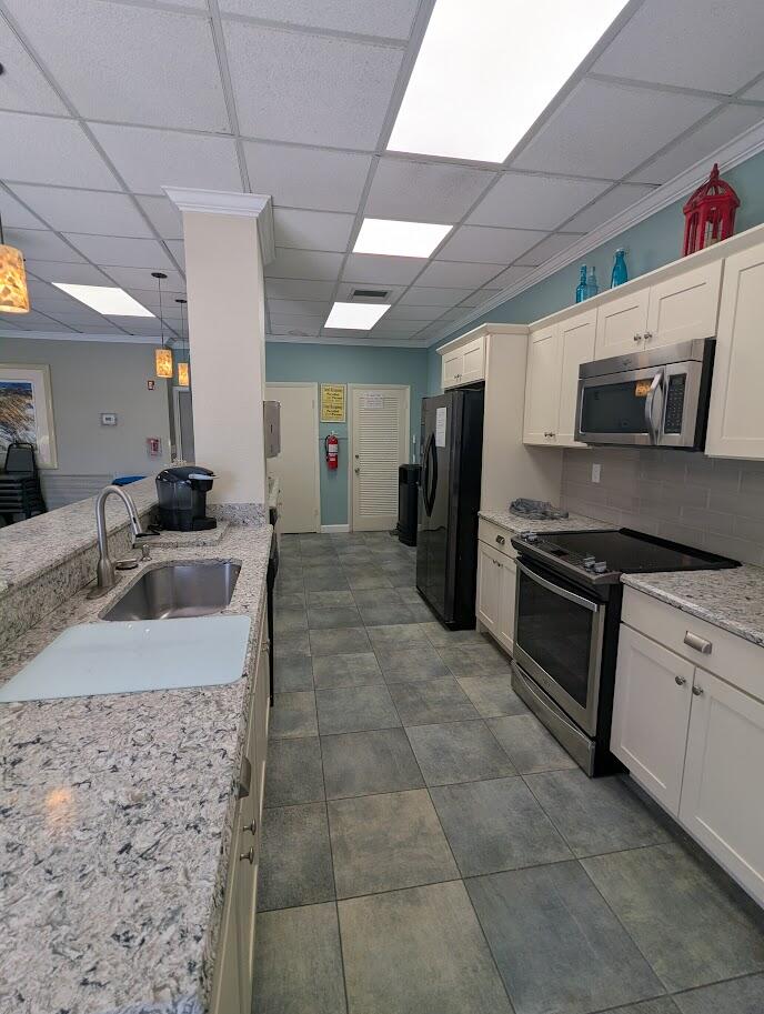 2121 North Ocean Boulevard, Unit 1006E Boca Raton, FL 33431 - Photo 55 of 64 a kitchen with stainless steel appliances granite countertop a sink stove and cabinets