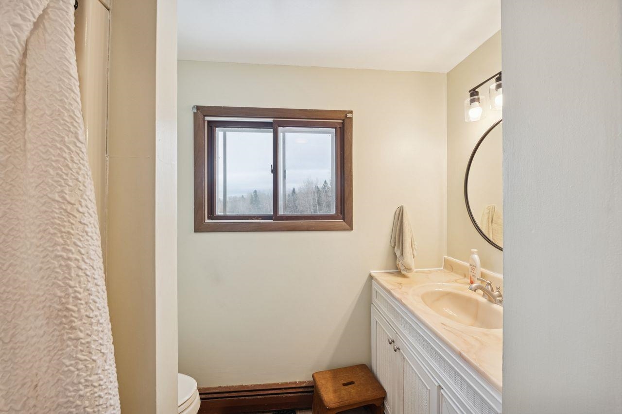 60609 Argo Road Mason, WI 54856 - Photo 14 of 29 Full bath featuring vanity and curtained shower