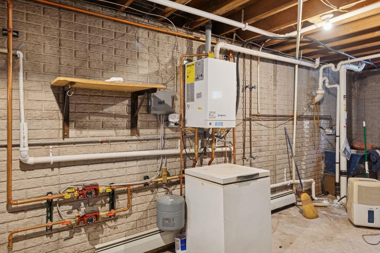 60609 Argo Road Mason, WI 54856 - Photo 17 of 29 Utility room featuring tankless water heater