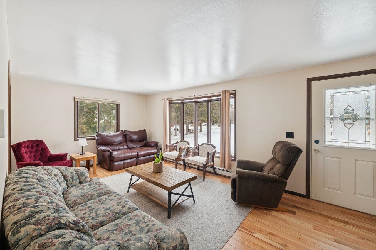 60609 Argo Road Mason, WI 54856 - Photo 3 of 29 Living area with light wood-style floors and a baseboard heating unit