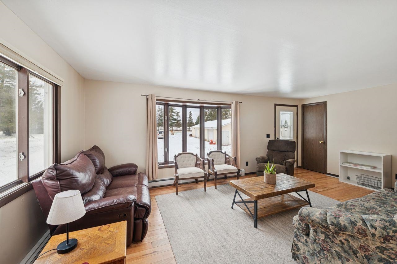 60609 Argo Road Mason, WI 54856 - Photo 5 of 29 Living area featuring light wood-style floors, a baseboard heating unit, and baseboard heating