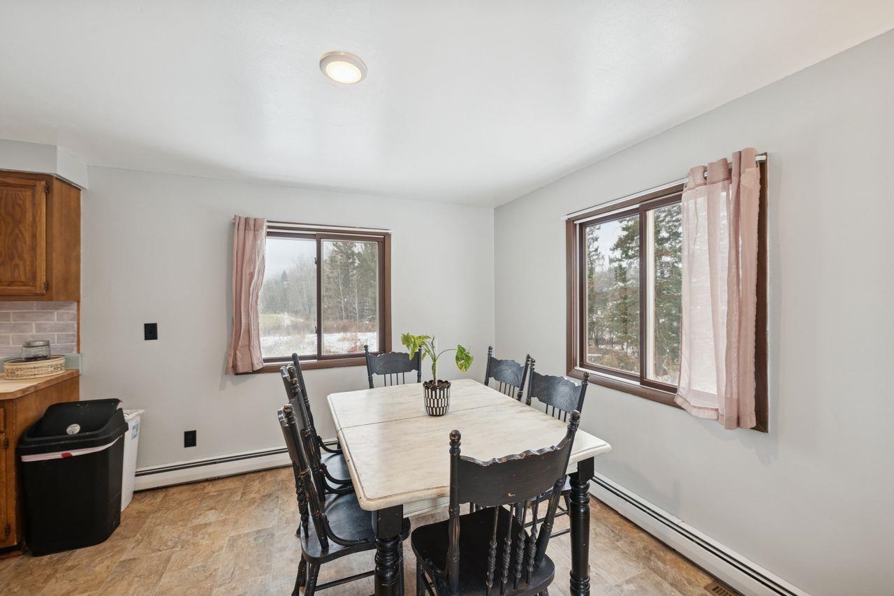 60609 Argo Road Mason, WI 54856 - Photo 7 of 29 Dining area with a baseboard heating unit, healthy amount of natural light, and stone finish floors