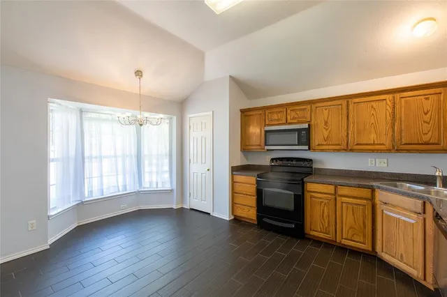 a kitchen with stainless steel appliances granite countertop a stove and a refrigerator