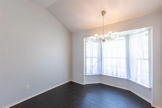 a view of a room with wooden floor and large windows