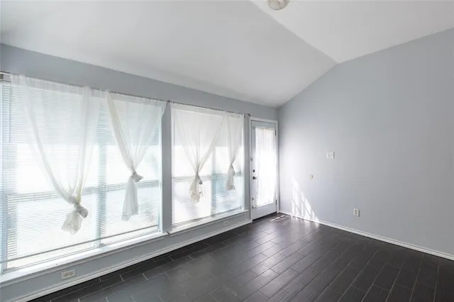 a view of wooden floor and windows in a room