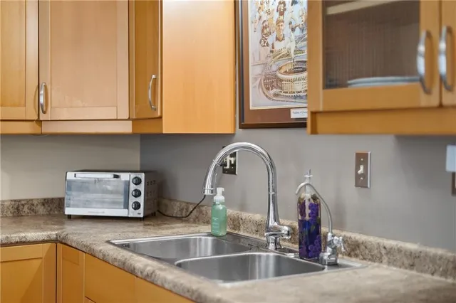 a kitchen with stainless steel appliances granite countertop a stove a sink dishwasher and a refrigerator